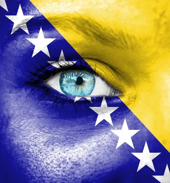 Woman face painted with flag of Bosnia and Herzegovina — Stock Photo, Image