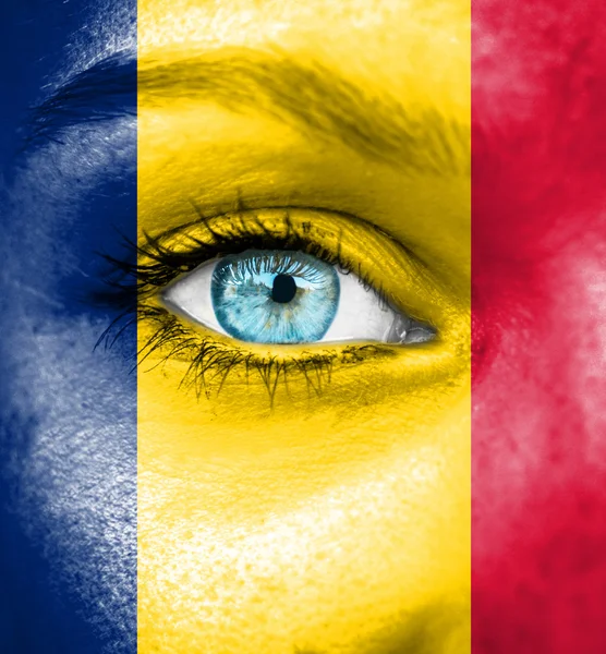 Woman face painted with flag of Chad — Stock Photo, Image