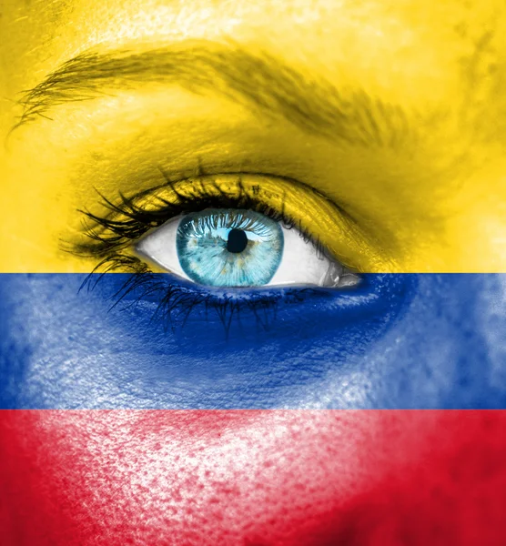 Ženská tvář s vlajka Kolumbie — Stock fotografie