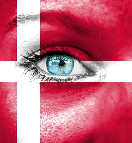 Woman face painted with flag of Denmark — Stock Photo, Image