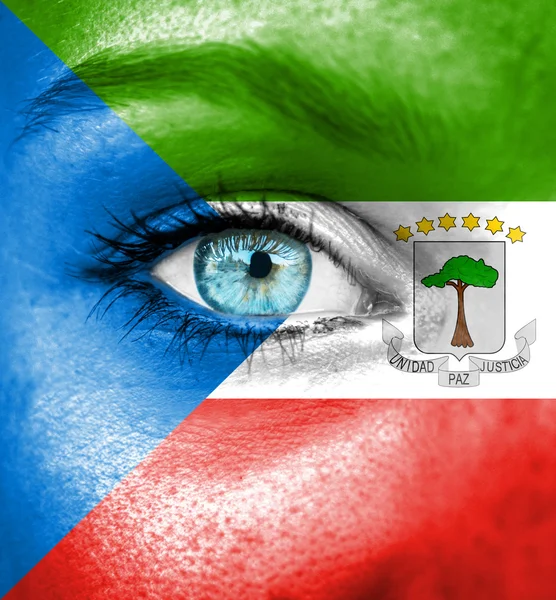 Woman face painted with flag of Equatorial Guinea — Stock Photo, Image