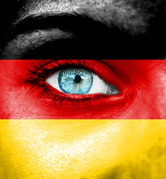 Woman face painted with flag of Germany — Stock Photo, Image