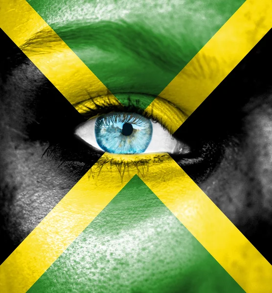 Woman face painted with flag of Jamaica — Stock Photo, Image