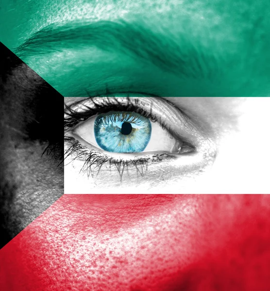 Woman face painted with flag of Kuwait — Stock Photo, Image