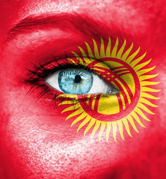 Woman face painted with flag of Kyrgyzstan — Stock Photo, Image