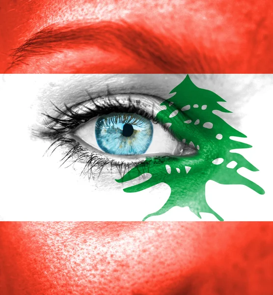 Woman face painted with flag of Lebanon — Stock Photo, Image