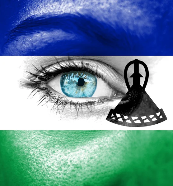 Woman face painted with flag of Lesotho — Stock Photo, Image