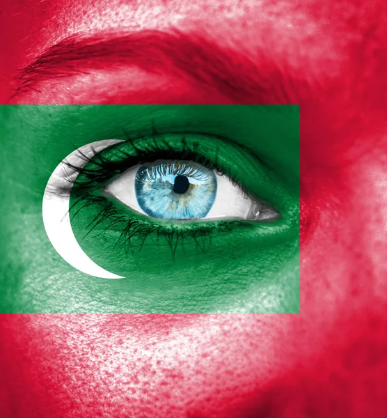 Woman face painted with flag of Maldives — Stock Photo, Image