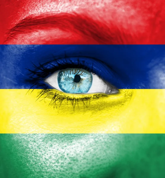 Woman face painted with flag of Mauritius — Stock Photo, Image