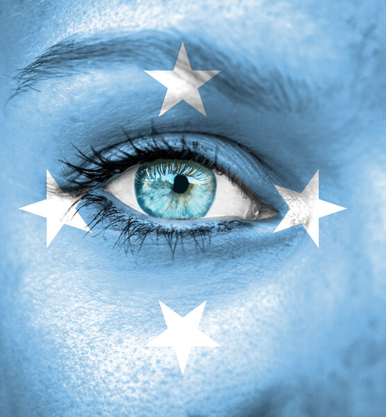 Woman face painted with flag of Micronesia