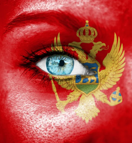 Woman face painted with flag of Montenegro — Stock Photo, Image