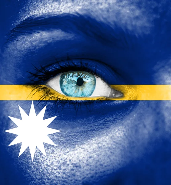 Woman face painted with flag of Nauru — Stock Photo, Image