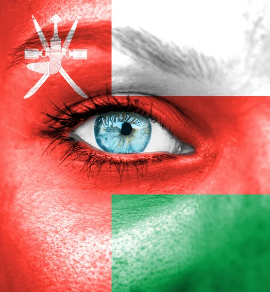 Woman face painted with flag of Oman — Stock Photo, Image