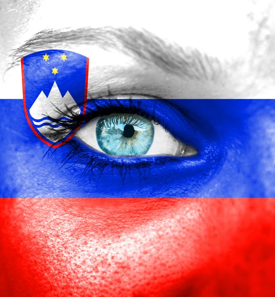 Woman face painted with flag of Slovenia — Stock Photo, Image