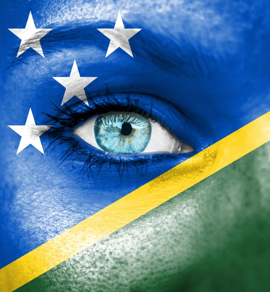 Woman face painted with flag of Solomon Islands — Stock Photo, Image