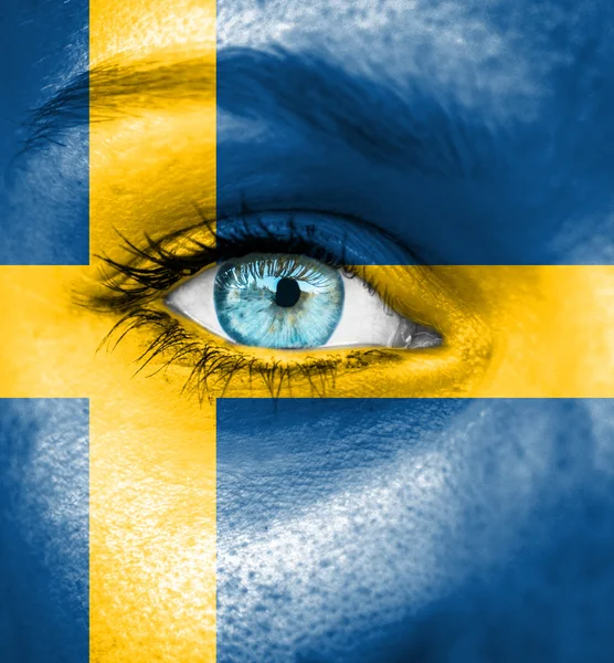 Woman face painted with flag of Sweden — Stock Photo, Image