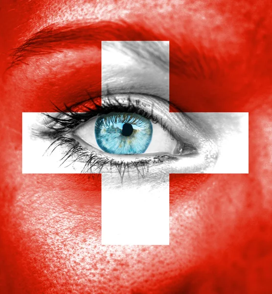 Woman face painted with flag of Swiss — Stock Photo, Image