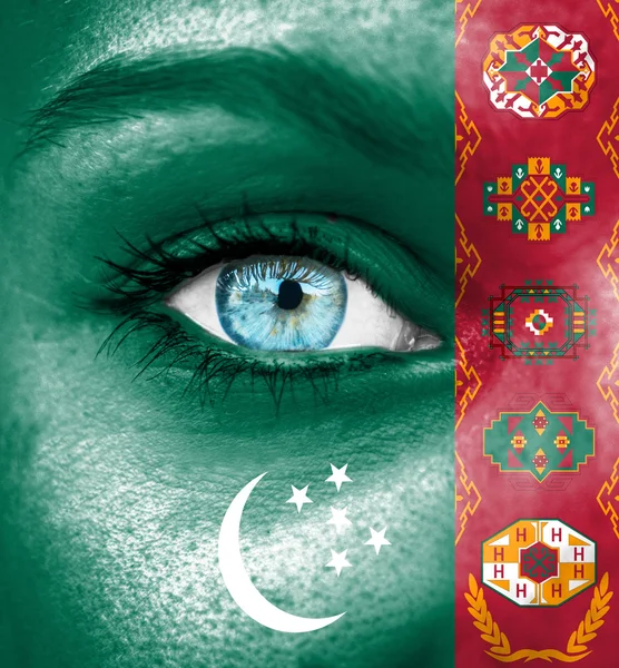 Woman face painted with flag of Turkmenistan — Stock Photo, Image