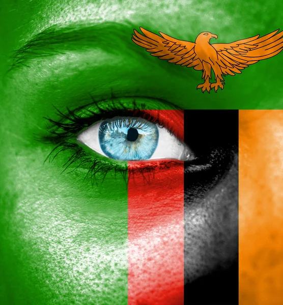 Woman face painted with flag of Zambia — Stock Photo, Image