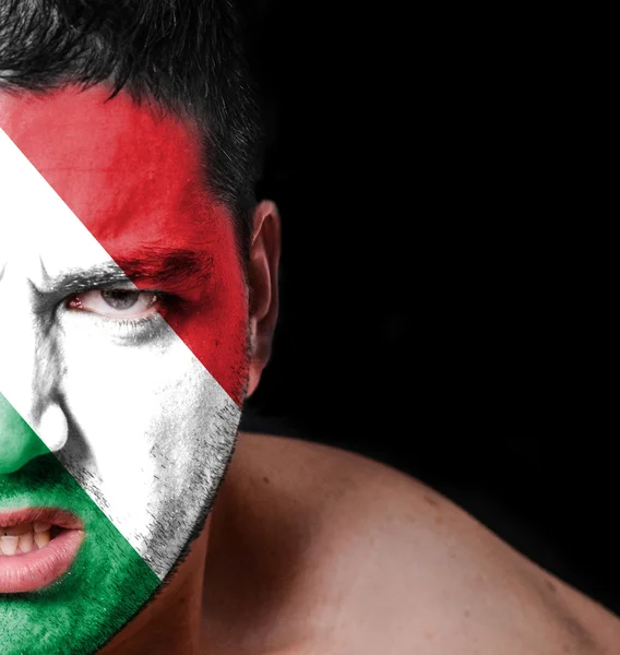 Portrait of angry man with painted flag of Hungary — Stock Photo, Image