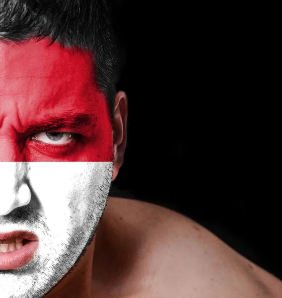 Portrait of angry man with painted flag of Indonesia — Stock Photo, Image