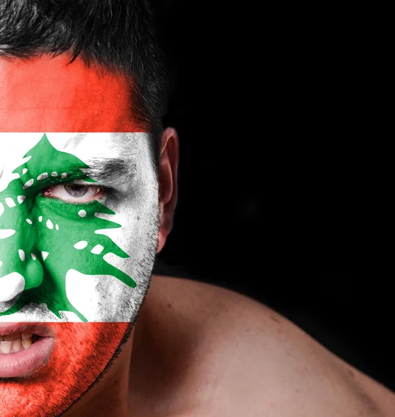 Portrait of angry man with painted flag of Lebanon — Stock Photo, Image