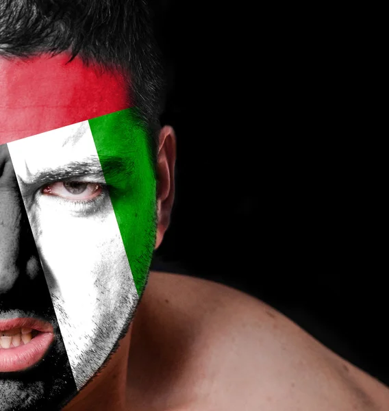 Portrait of angry man with painted flag of United Arab Emirates — Stock Photo, Image