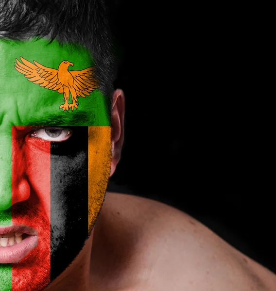 Portrait of angry man with painted flag of Zambia — Stock Photo, Image