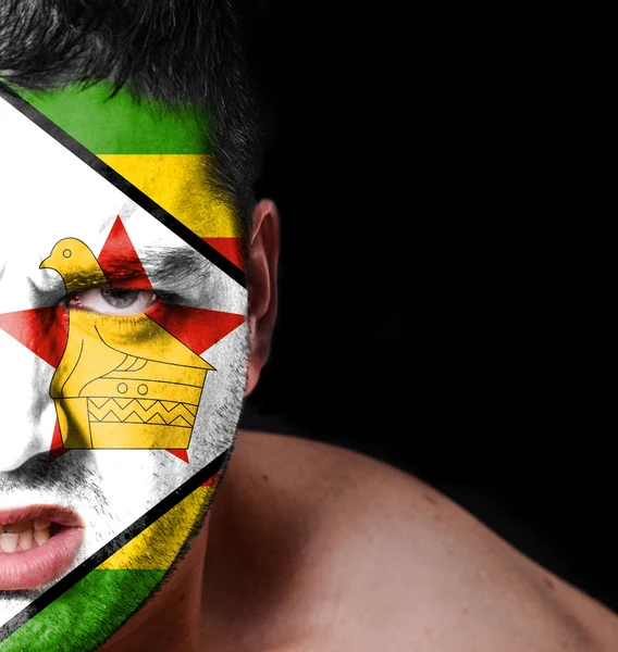 Portrait of angry man with painted flag of Zimbabwe — Stock Photo, Image