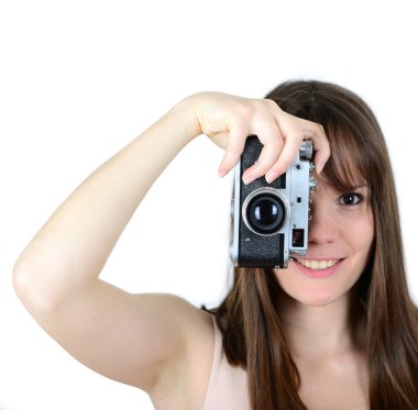 Portrait of beautiful female holding vintage camera with focus o