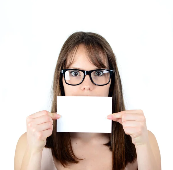 Businesswoman holding blank paper covering her mouth against whi — Stock Photo, Image