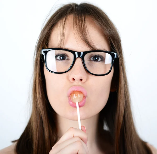 Beautiful female licking a red shiny lollipop — Stock Photo, Image