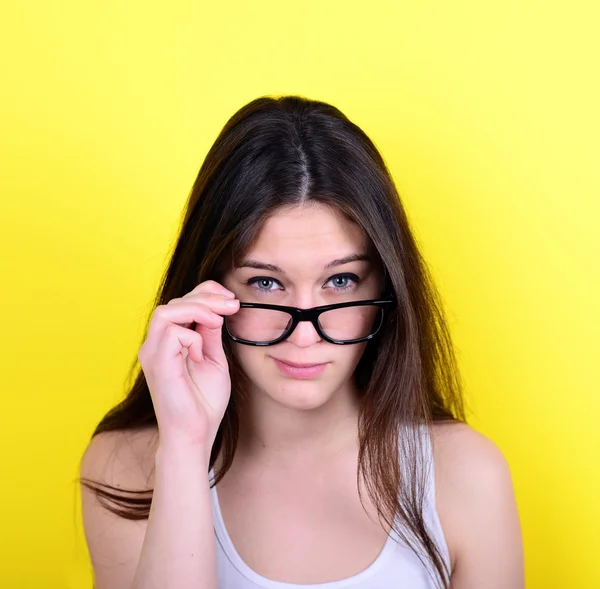 Portrait of strict young woman against yellow background — Stock Photo, Image