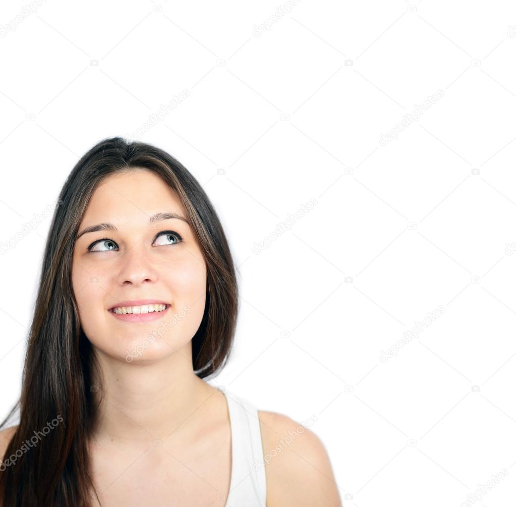 Portrait of beautiful girl thinking and looking up against white