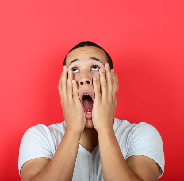 Portrait of desperate man against red background — Stock Photo, Image