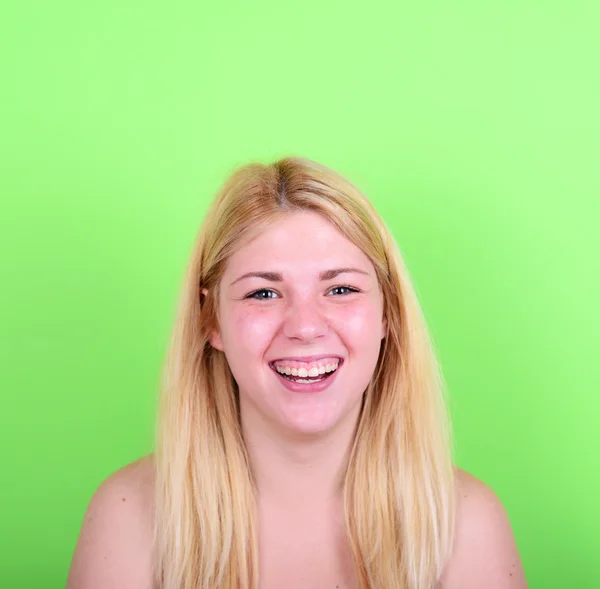 Portrait of beautiful young woman smiling against green backgrou — Stock Photo, Image