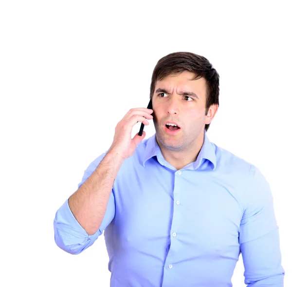 Shocked businessman talking on phone — Stock Photo, Image