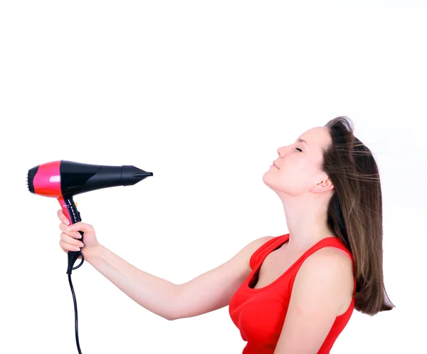 Woman with long hair holding strong blow dryer isolated on white — Stock Photo, Image