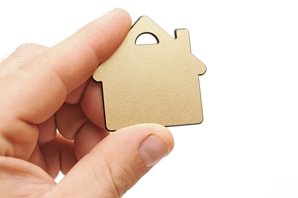 Złoty metaliczny mały dom w ręku — Zdjęcie stockowe