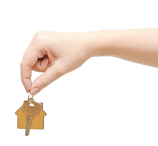 Hand with chrome house key isolated on white — Stock Photo, Image