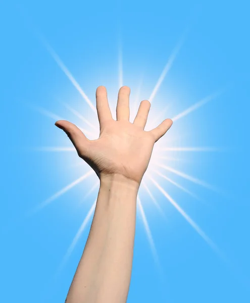 Hand holding the sun over blue sky — Stock Photo, Image