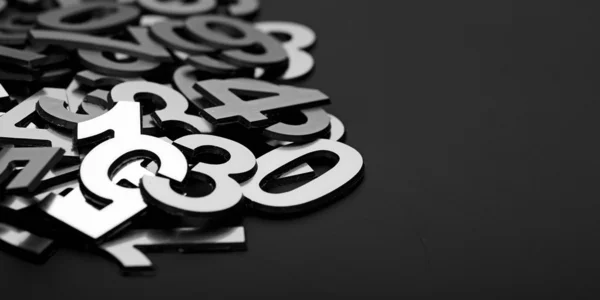 Closeup image with pile metal numbers on black background — Stock Photo, Image