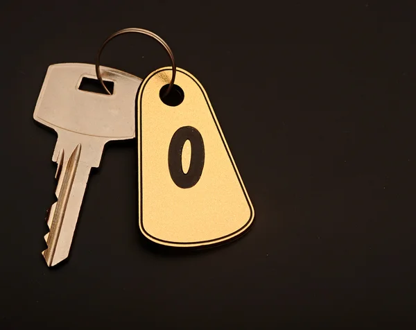 Room key on black background with number 0 — Stock Photo, Image