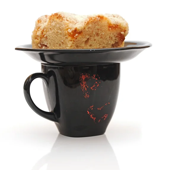 Black cup and piece cake — Stock Photo, Image