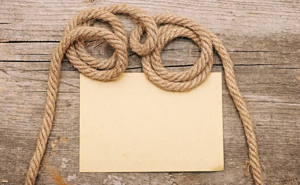 Parchment paper and ship ropes on wood — Stock Photo, Image