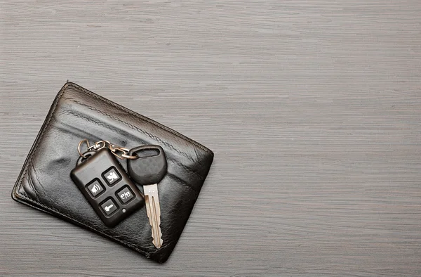 Car keys and documents on dark wooden background — Stock Photo, Image