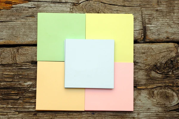 Stack of colorful sticky notes on wooden background — Stock Photo, Image