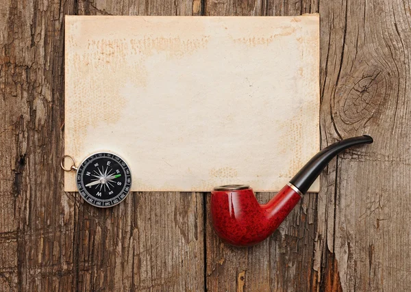 Compass and pipe on the old paper background — Stock Photo, Image