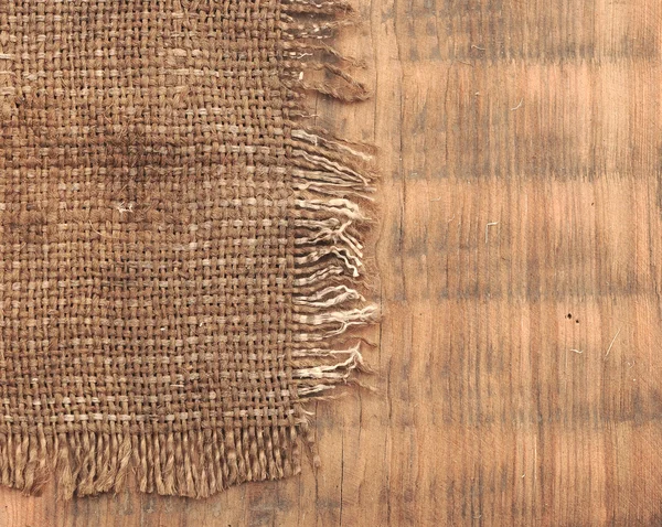 Lona de yute de arpillera fondo vintage sobre tablas de madera —  Fotos de Stock