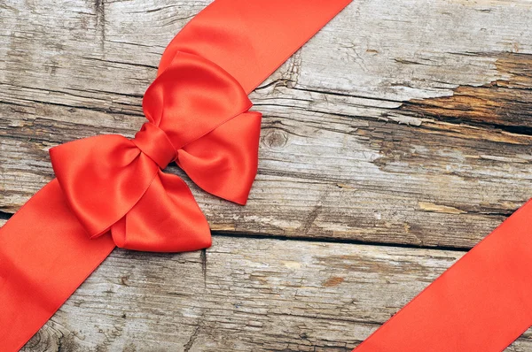 Red bow on wood background — Stock Photo, Image